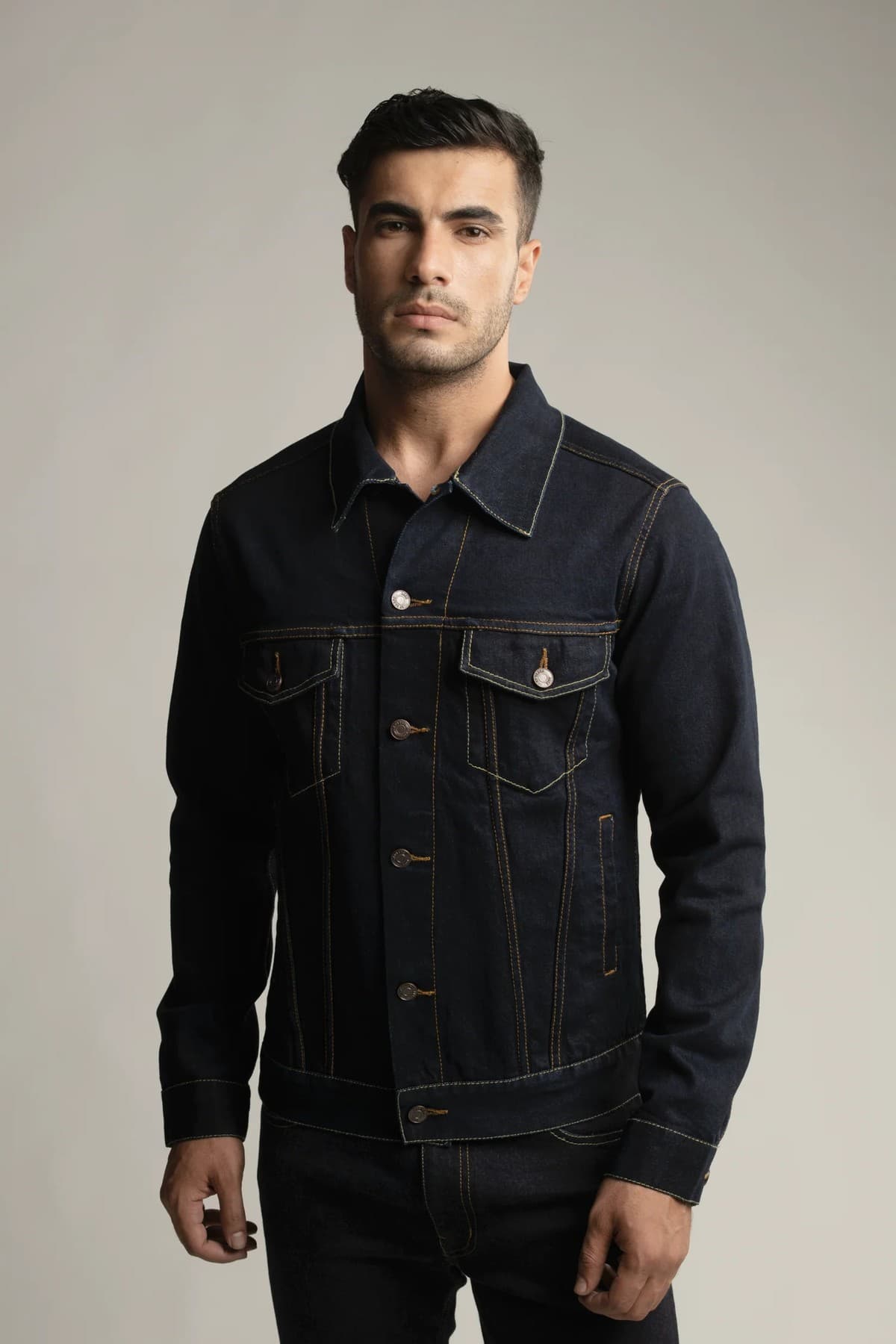 A man in a dark denim jacket