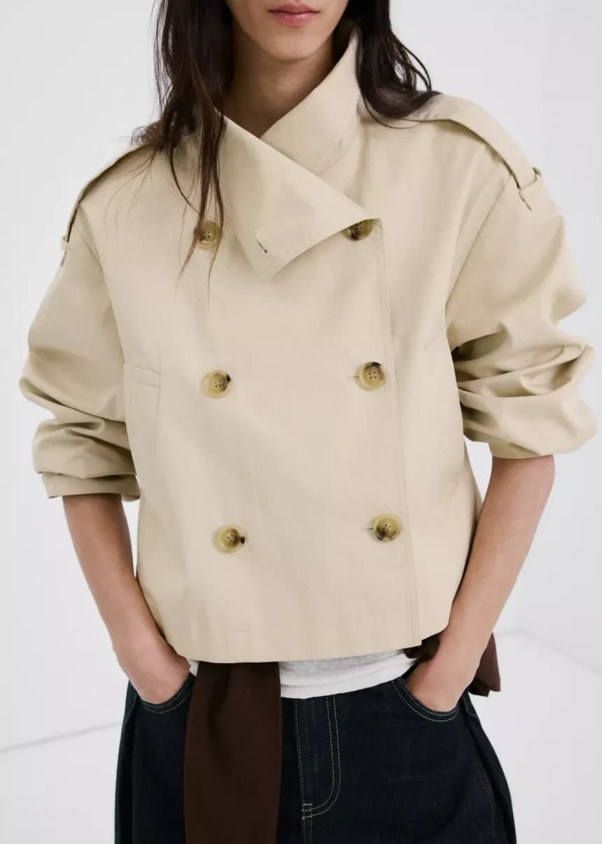 Cream cropped double-breasted trench jacket worn with jeans