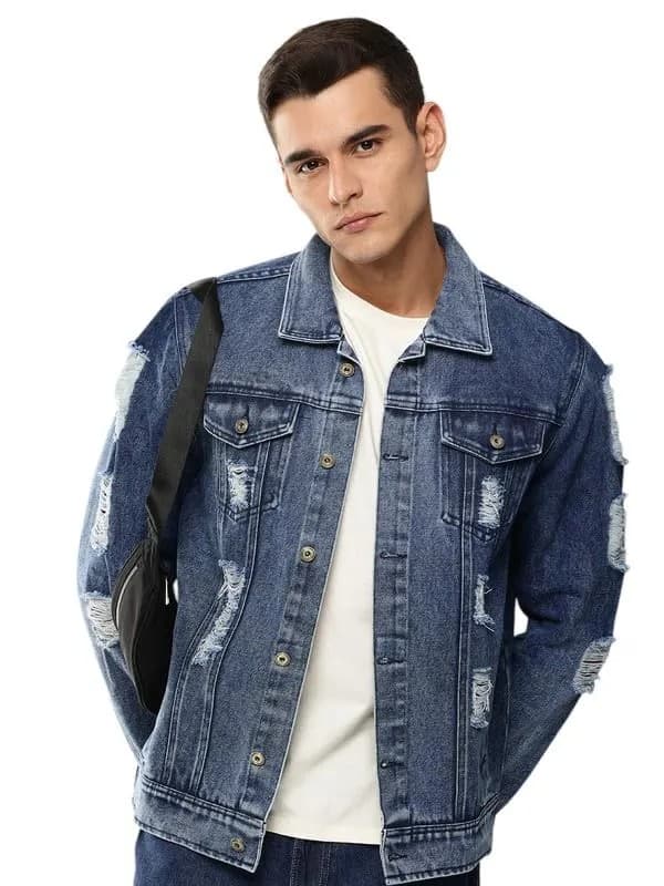 Mid indigo distressed denim jacket worn over a white tee