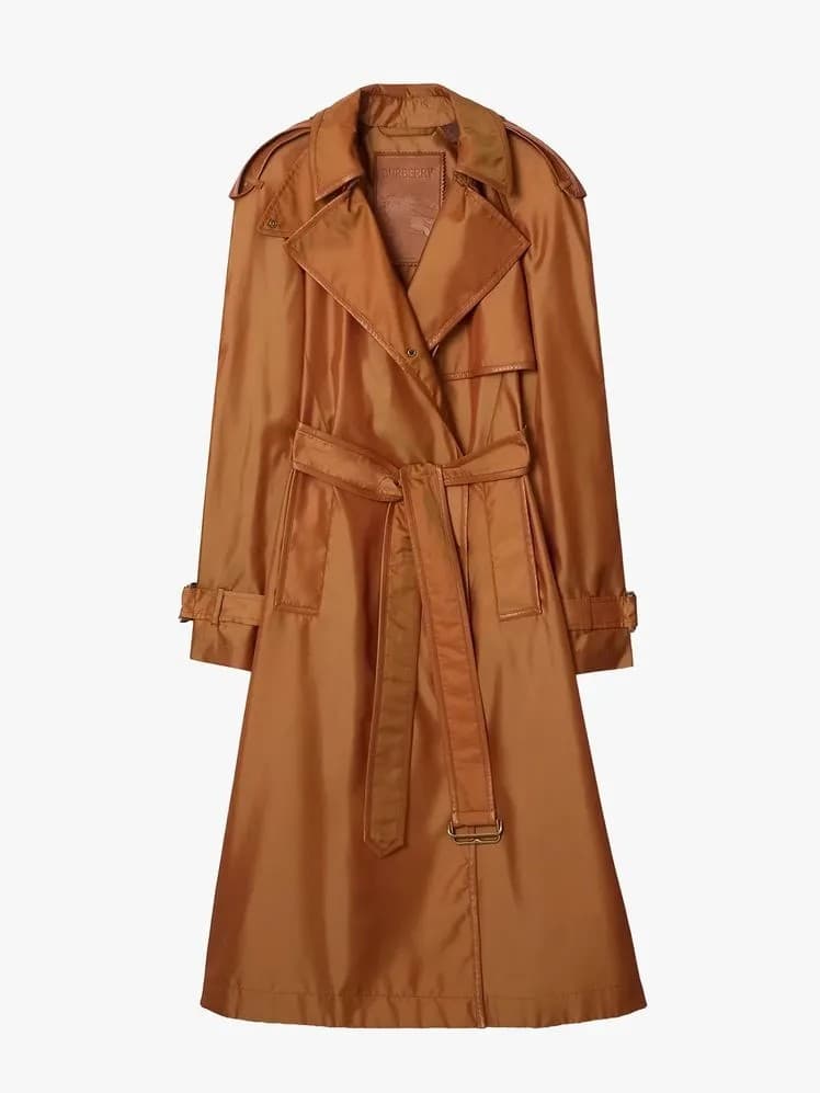 Rust belted trench coat laid flat, front view